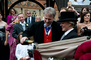 Essex Toastmaster pouring champagne for the bride and bridegroom outside St. Mary's Church, Great Baddow