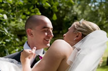 Bride being carried off by her bridegroom on their wedding day in Essex