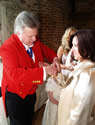 Essex toastmaster assisting wedding guests with button holes at Gaynes Park