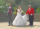 Toastmaster Richard Palmer assisting a bride with her wedding dress