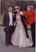 Wedding toastmaster Richard Palmer keeping the bride warm with my heavy cloak