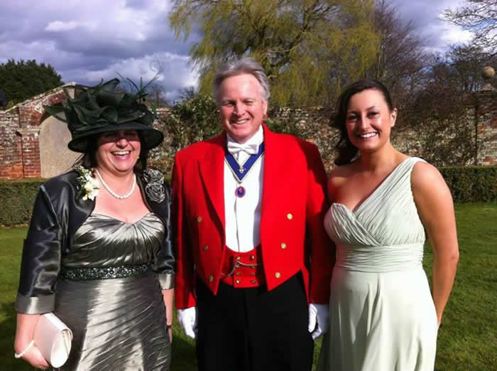 Toastmaster with the mother and sister of the groom
